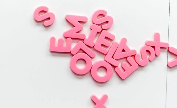 pink letters laid out for learning how to play hangman